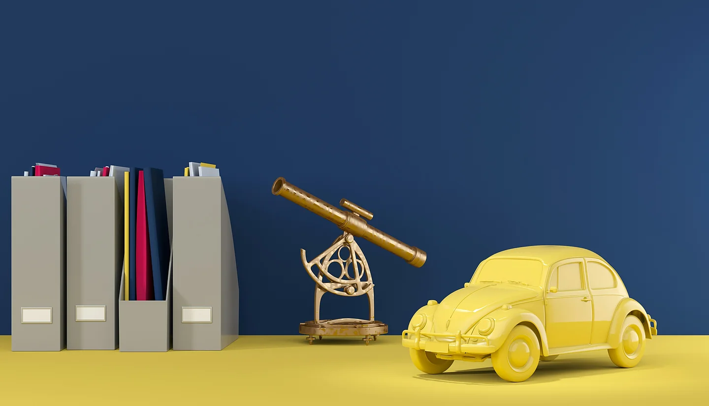 Aktenordner, Teleskop und ein gelbes Auto